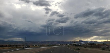 Photo for A panoramic shot of the road between with hills in the background against a clouded sky - Royalty Free Image