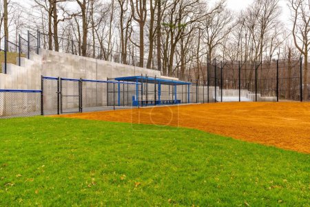 Photo for View of typical nondescript high school softball clay infield looking from outfield toward the first base dugout. No people visible. - Royalty Free Image