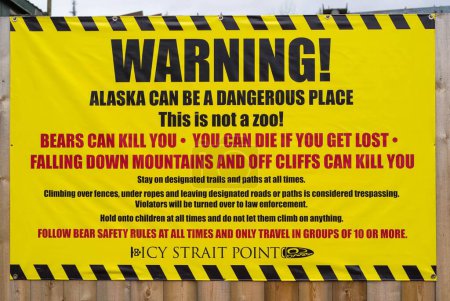 Foto de Una señal de advertencia para los turistas a Icy Straight Point para tener cuidado con los osos y otros peligros que amenazan la vida - Imagen libre de derechos