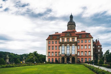 An outdoor view of the Ksiaz Palace and greenfield in Southern Poland