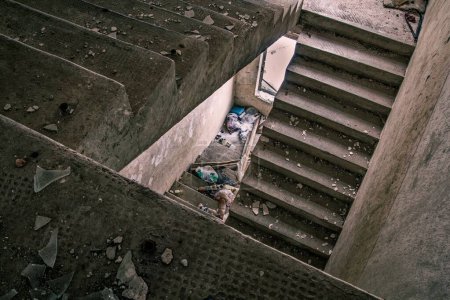 Foto de Un interior de una vieja escalera en un edificio abandonado en ruinas después de la guerra - Imagen libre de derechos