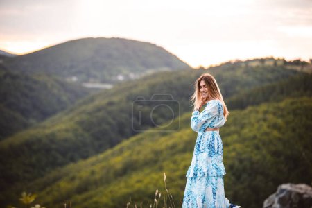 Photo for A young female standing near the hills - Royalty Free Image