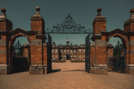 Photo for The opened gates lead to the Hanbury Hall building before the blue skyline - Royalty Free Image