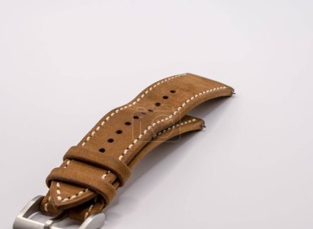 detailed close up of a vintage camel oak leather watch strap with brushed stainless steel metal pin and buckle