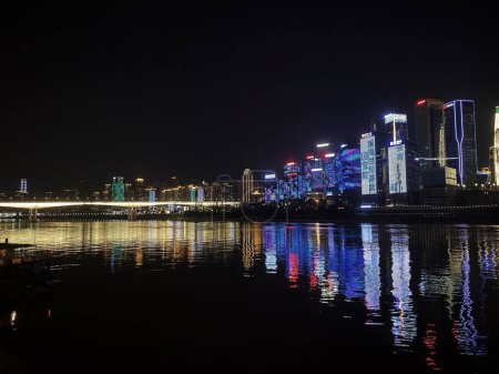 Foto de La hermosa vista de los edificios iluminados de la ciudad reflejada en la superficie del río Yangtze. - Imagen libre de derechos