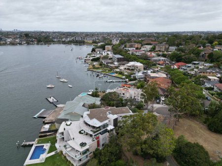 Photo for An aerial view of a coastal town with different buildings and boats against a cloudy sky - Royalty Free Image
