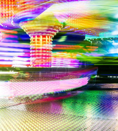 Photo for A vertical colorful long-exposure shot of the 'Twister' ride - fun fair - Royalty Free Image