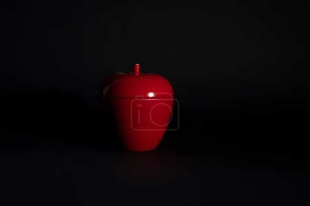Photo for A red, apple-shaped candle isolated on black - Royalty Free Image