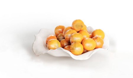 Photo for An illustration of ripe oranges on a white plate isolated on white background - Royalty Free Image