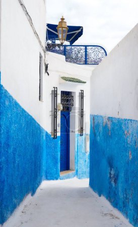 Téléchargez les photos : Une ruelle étroite entre les murs bleus et blancs dans la Kasbah du quartier d'Udayas - en image libre de droit