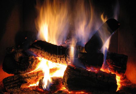 Photo for A closeup shot of firewood burning with big flames during the winter - Royalty Free Image