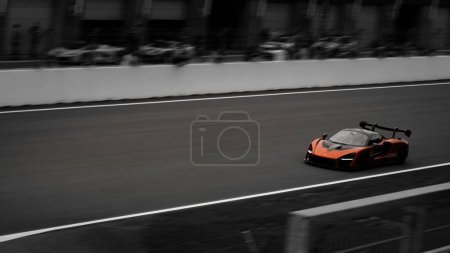 Photo for An orange McLaren Senna on the racetrack. Assen, Netherlands. - Royalty Free Image