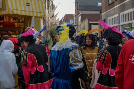 Photo for The people in costumes in Delft celebrating Sinterclas or Sinterklass during winter season and Christmas - Royalty Free Image