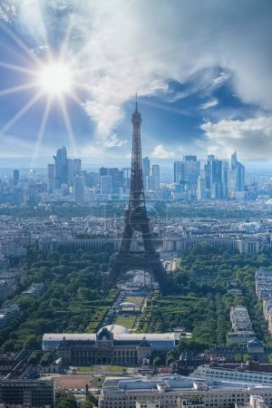 Photo for Paris, aerial view of the Eiffel Tower in backlight, sun star, with the Defense towers in background - Royalty Free Image