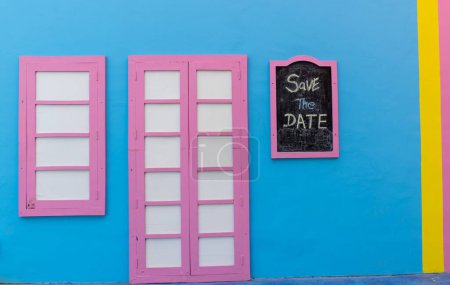 Photo for A beautiful view of pink framed window and door on the blue wall - Royalty Free Image
