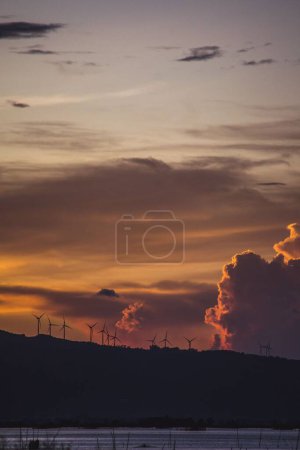 Photo for The windmills of Pililia on top of some parts Sierra Madre Mountain Range in Rizal at sunset - Royalty Free Image
