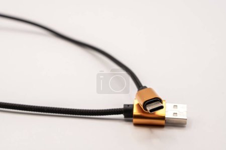 Photo for Detailed close up of a black braided USB cable with golden colour connectors - Royalty Free Image