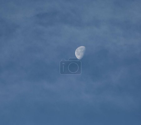 Photo for The bright moon in the clouded sky during the daylight - Royalty Free Image