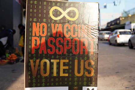 Photo for A closeup shot of a board with an infinity sign and the words 'no vaccine passport', 'vote us' - Royalty Free Image