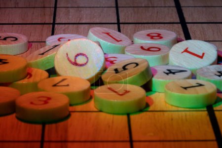Photo for A pile of wooden round tokens with numbers - Royalty Free Image