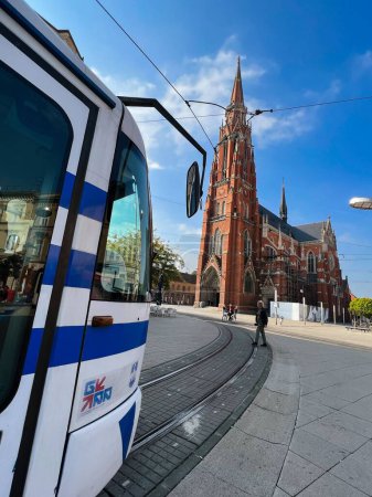 Photo for A vertical view of a bus arriving at the Cathedral of St. Peter and St. Paul on a sunny day - Royalty Free Image