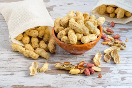 Photo for A bowl full of peanuts and more peanuts in a sack - Royalty Free Image