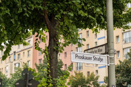 Photo for A road sign of Proskauer Strasse on the background of a beige building in Berlin, Germany - Royalty Free Image