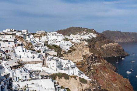 Photo for A beautiful view of whitewashed buildings and the coast in Oia, Santorini, Greece. - Royalty Free Image