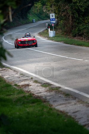 Photo for A red car set up during an uphill speed race of the Italian championship in Pesaro - Royalty Free Image