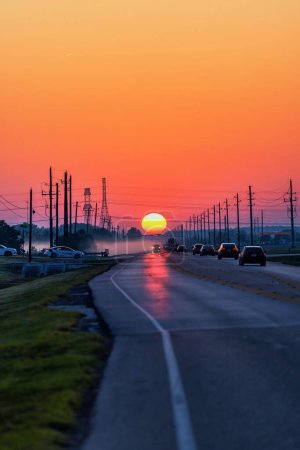Photo for A vertical shot of a road with mesmerizing sunrise sky in the background - Royalty Free Image