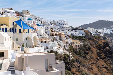 Photo for The village of Oia with typical white cave houses on a sunny day - Royalty Free Image