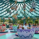 A beautiful shot of people enjoying the Mad Hatter's Tea Cups' carousel in Disneyland, Paris, France