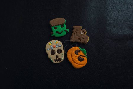 Photo for A closeup of Halloween cookies in black background - Royalty Free Image