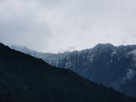 Photo for A beautiful view of mountains peaks on a cloudy foggy day - Royalty Free Image