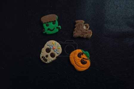 Photo for A closeup of Halloween cookies in black background - Royalty Free Image