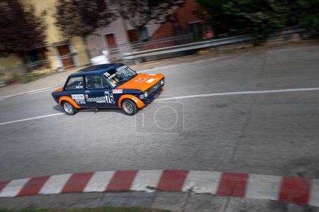 Photo for A blue and orange car set up during an uphill speed race of the Italian championship in Pesaro - Royalty Free Image