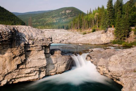 A long exposure of the water flowing down of the pictureque Elbow Falls in Alberta, Canada