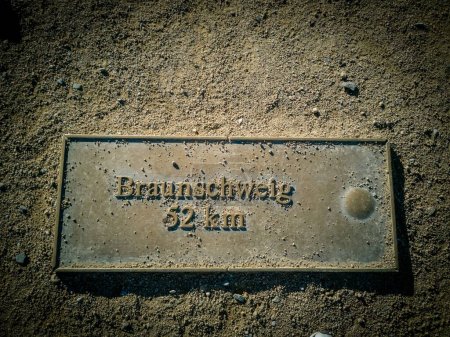 Un panneau métallique indiquant Braunschweig 52 km