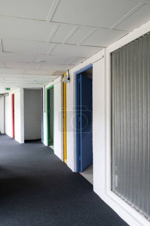 Photo for A corridor with urban modern colorful doors at Le Corbusier Masterpiece building - Royalty Free Image