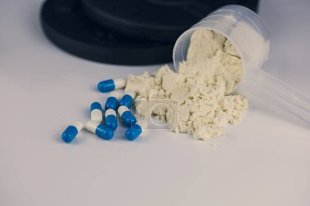 Photo for A powder in scoop with pills - Royalty Free Image