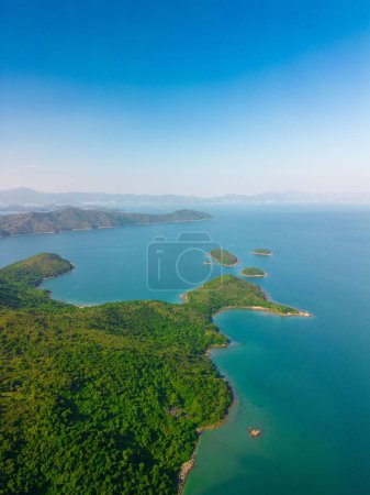 Photo for A vertical drone shot of green-covered coasts of a sea, cool for background - Royalty Free Image