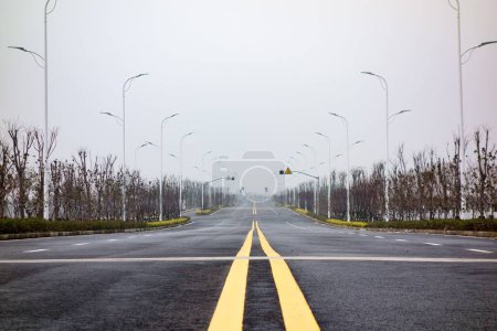 Photo for The empty road with yellow lines against the background of the sky. - Royalty Free Image