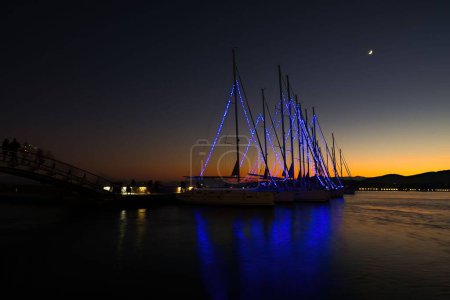 Photo for Beautiful sailboats in the harbor decorated at sunset, Volos, Greece - Royalty Free Image