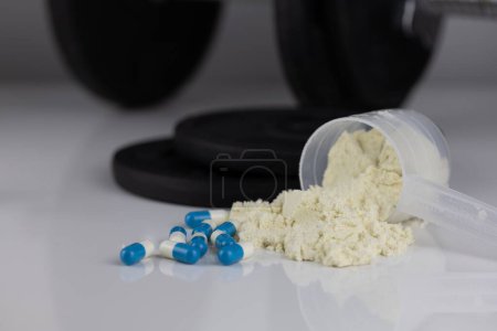 Photo for A powder in scoop with pills - Royalty Free Image