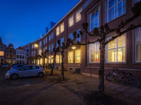 Photo for The exterior of EICAS building in Deventer during blue hour and parked cars in front of it, in Netherlands - Royalty Free Image