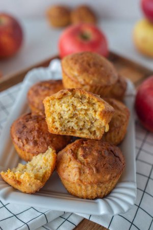 Photo for A closeup of an apple carrot muffin with a blurred apple background - Royalty Free Image