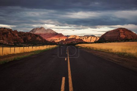 Photo for A low-angle shot of a road leading to the mountains in Utah, USA - Royalty Free Image