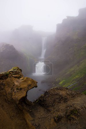 Photo for A vertical shot of a waterfall during the day under the clouds - Royalty Free Image