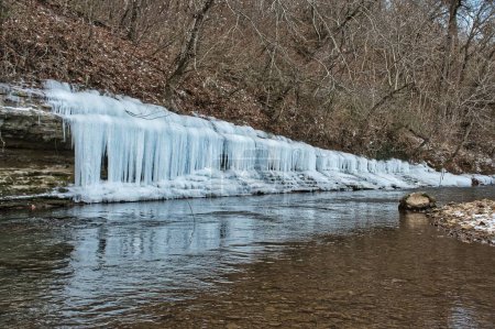 Photo for A closeup view of a iced waterfall next to the forest - Royalty Free Image