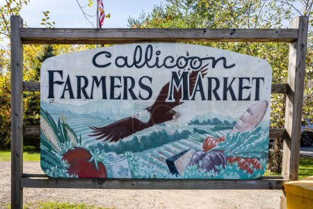 Foto de Un primer plano de una pancarta en un soporte de madera que dice "Mercado de agricultores Callicoon" - Imagen libre de derechos